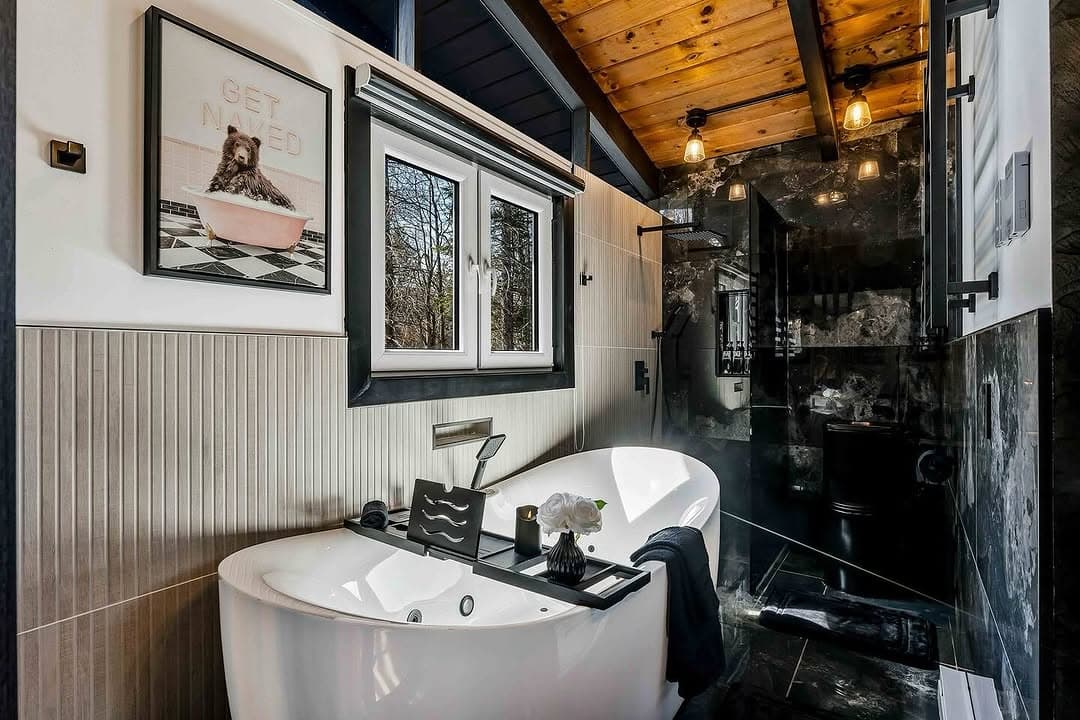 Luxury bathroom with soaking tub and wood-beam ceiling ready for move-in