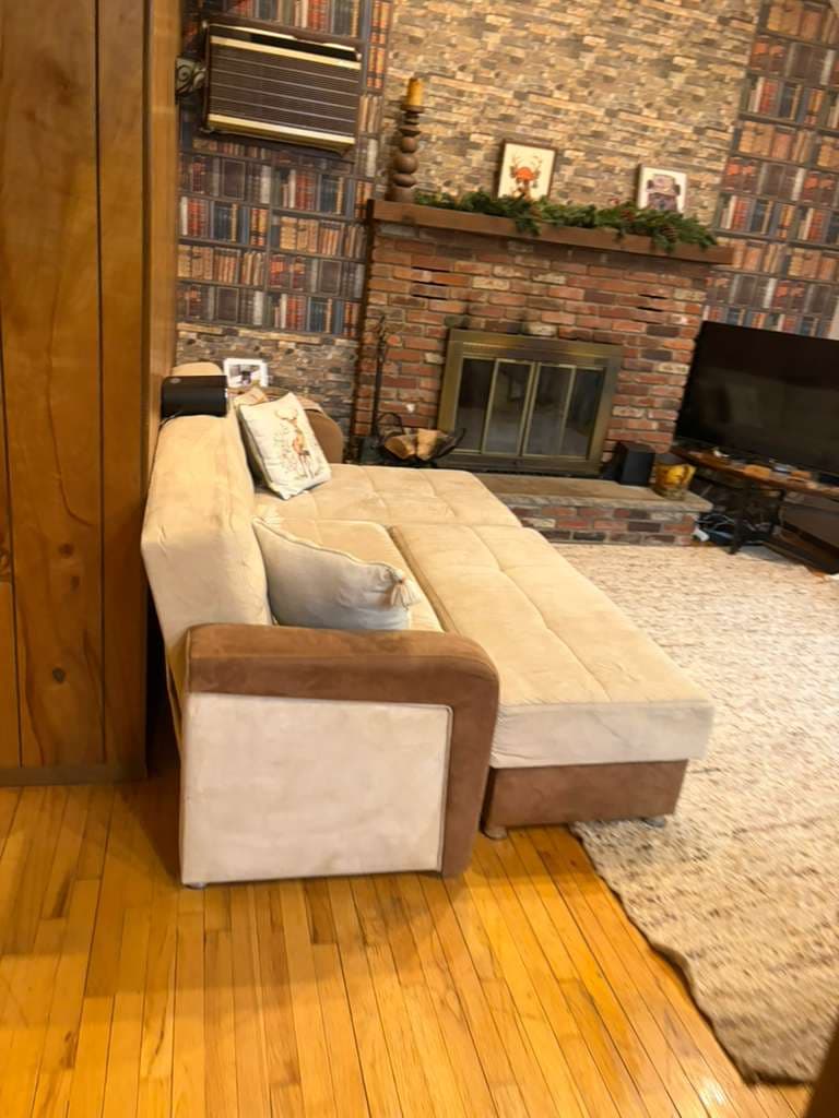 Clean living room with brick fireplace